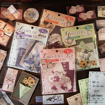 Assorted vintage scrapbooking ephemera pack with retro-themed designs spread across a wooden table