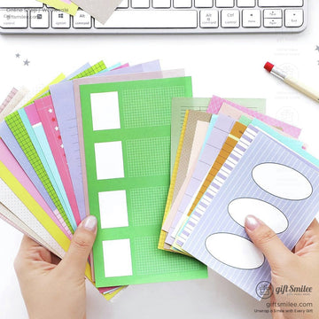 Hands holding colorful journaling and scrapbook papers with various designs