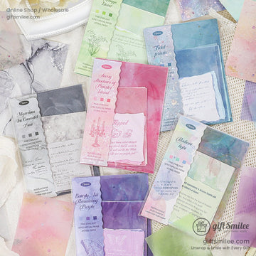 Assorted pastel watercolor scrapbooking paper with pink and green tones, perfect for DIY crafts and journaling