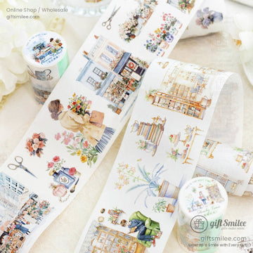 Close-up of vintage-inspired washi tape rolls featuring floral, coffee shop, and retro market designs