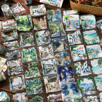 A variety of vintage travel-themed watercolor stickers displayed on a wooden table