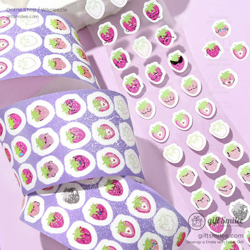 Glittery kawaii strawberry stickers on a purple washi tape roll with adorable expressions