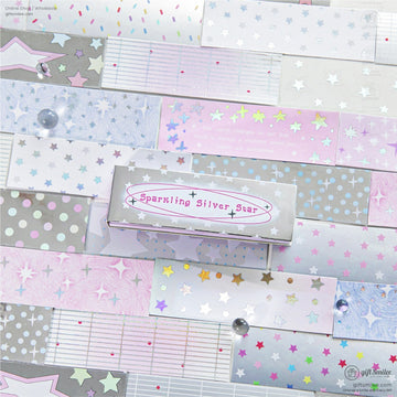 A close-up of pastel holographic star stickers on a colorful, decorative background