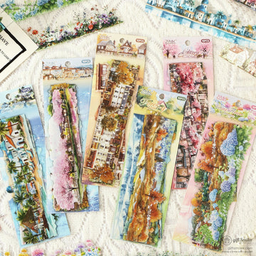 Close-up of six packs of scenic washi stickers featuring landscapes, cherry blossoms, and natural scenery