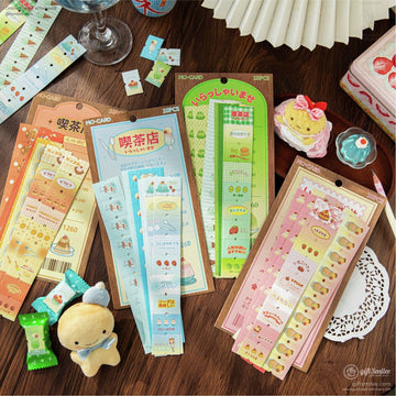 A variety of cute Japanese retro cafe-themed washi stickers featuring food and drink designs on a wooden table