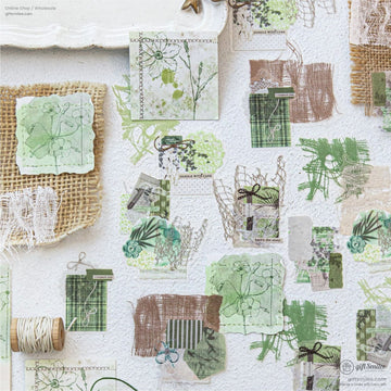 A beautiful collection of floral and lace-inspired scrapbook pieces arranged aesthetically on a textured surface