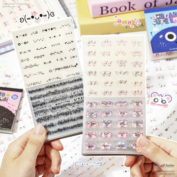 Close-up of kawaii emoji sticker sheets with adorable face designs and pastel colors