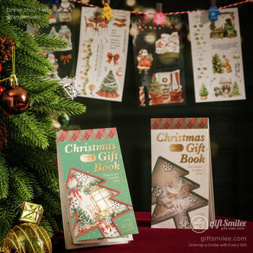 Christmas gift book displayed near a festive tree with ornaments