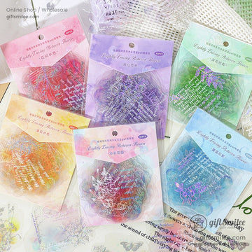 A collection of colorful floral ephemera stickers in pink, purple, and green packaging, perfect for scrapbooking and journaling