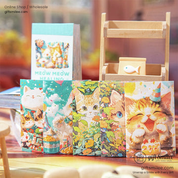 Close-up of five whimsical cat-themed notebooks arranged with vibrant illustrations of nature and cats