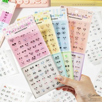 Close-up of pink and pastel anime face expression stickers with cute designs