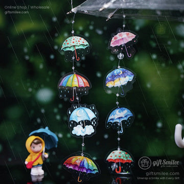 Close-up of colorful umbrella stickers hanging decoratively with a rainy background