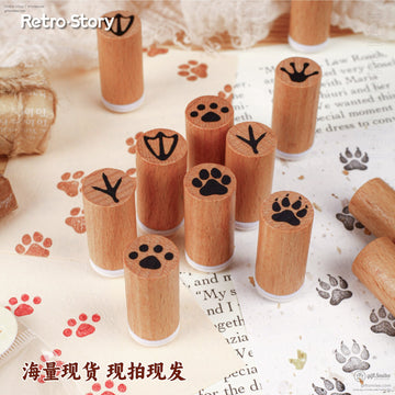 Set of wooden rubber stamps with animal paw prints on a crafting table