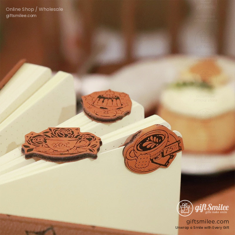 Book with opened pages showcasing magnetic bookmarks in tea and dessert designs.