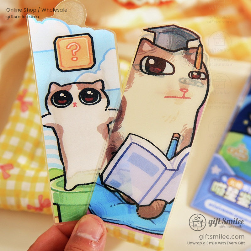 Close-up of cat bookmarks, including a cat reading a book and a curious cat with big eyes
