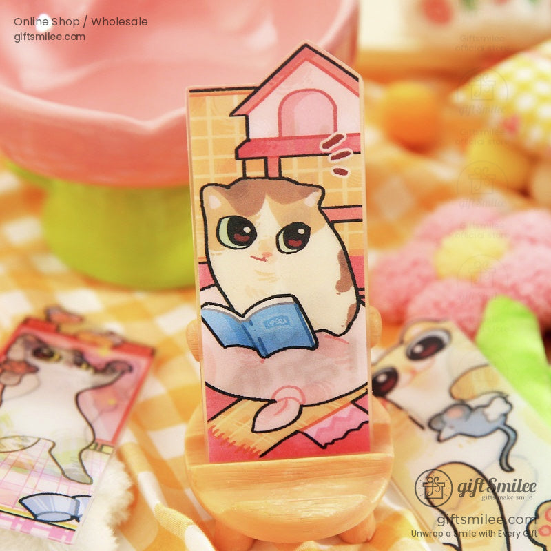 Magnetic cat bookmark with a playful kitten design sitting near a book