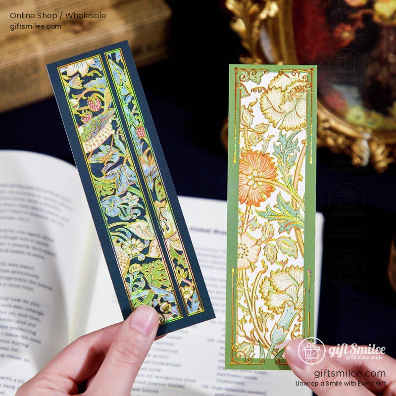 Two unique holographic bookmarks, one in green and the other in navy, held by hand over an open book