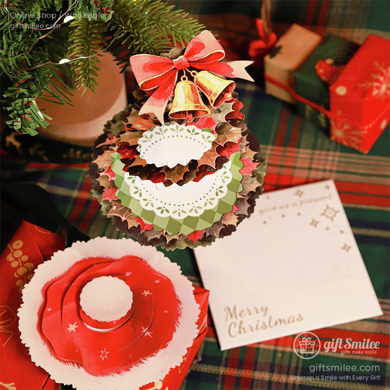 Close-up of a 3D pop-up Christmas card with a festive wreath design and Merry Christmas text