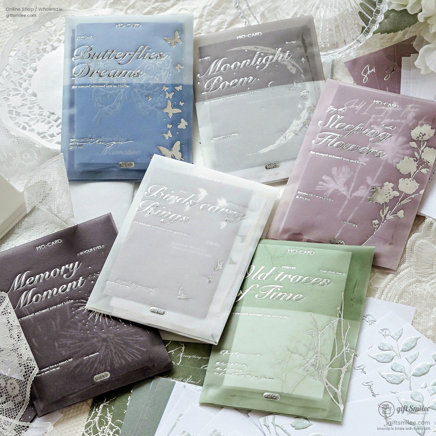 Nature-inspired stationery packs with elegant silver foil designs, featuring themes like butterflies, flowers, and moons