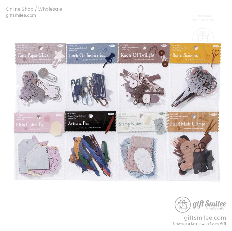 Packaged vintage stationery supplies, showcasing paper clips, tags, and decorative accents for journaling