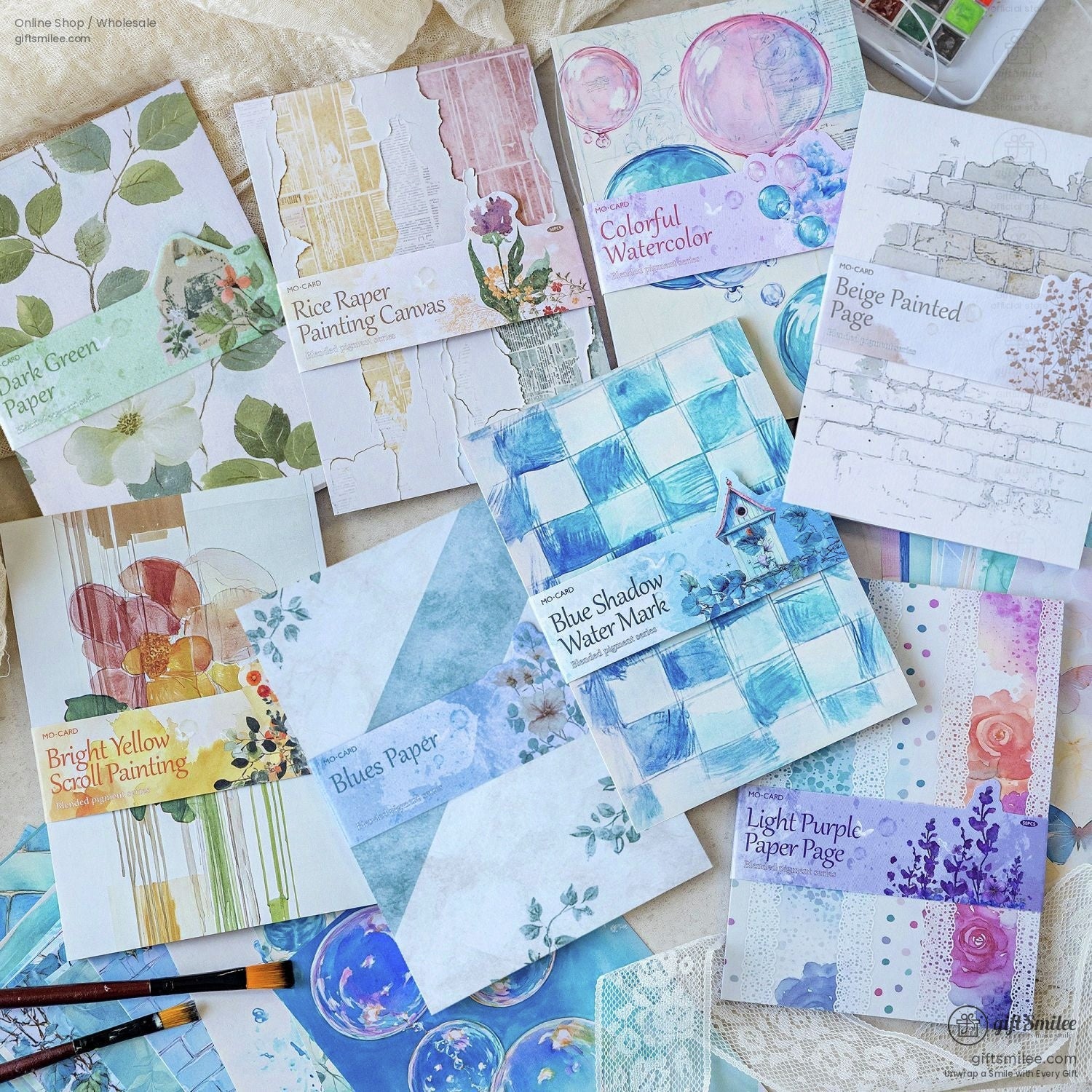 Close-up view of vintage-inspired art journaling papers featuring floral and geometric patterns