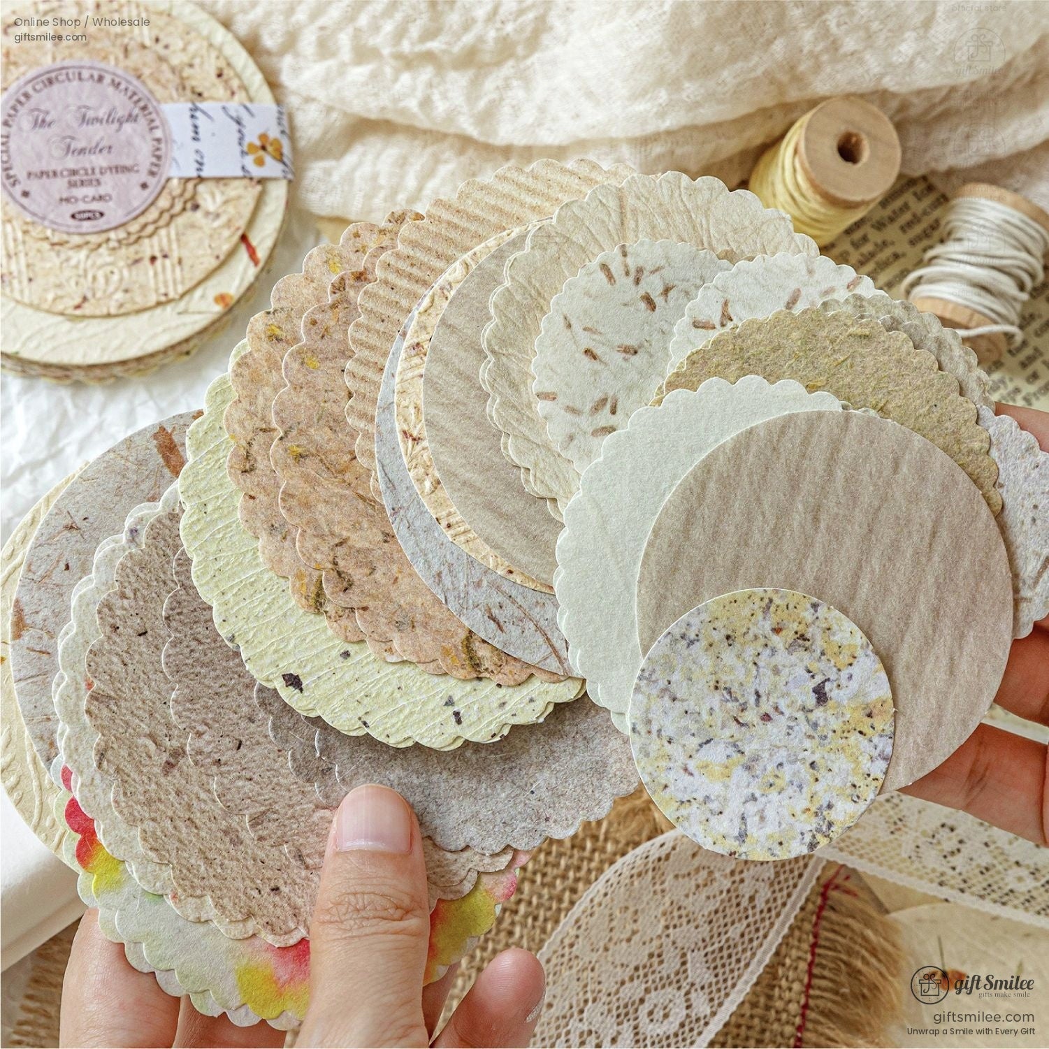A close-up of scalloped decorative paper circles in soft earthy tones for crafting