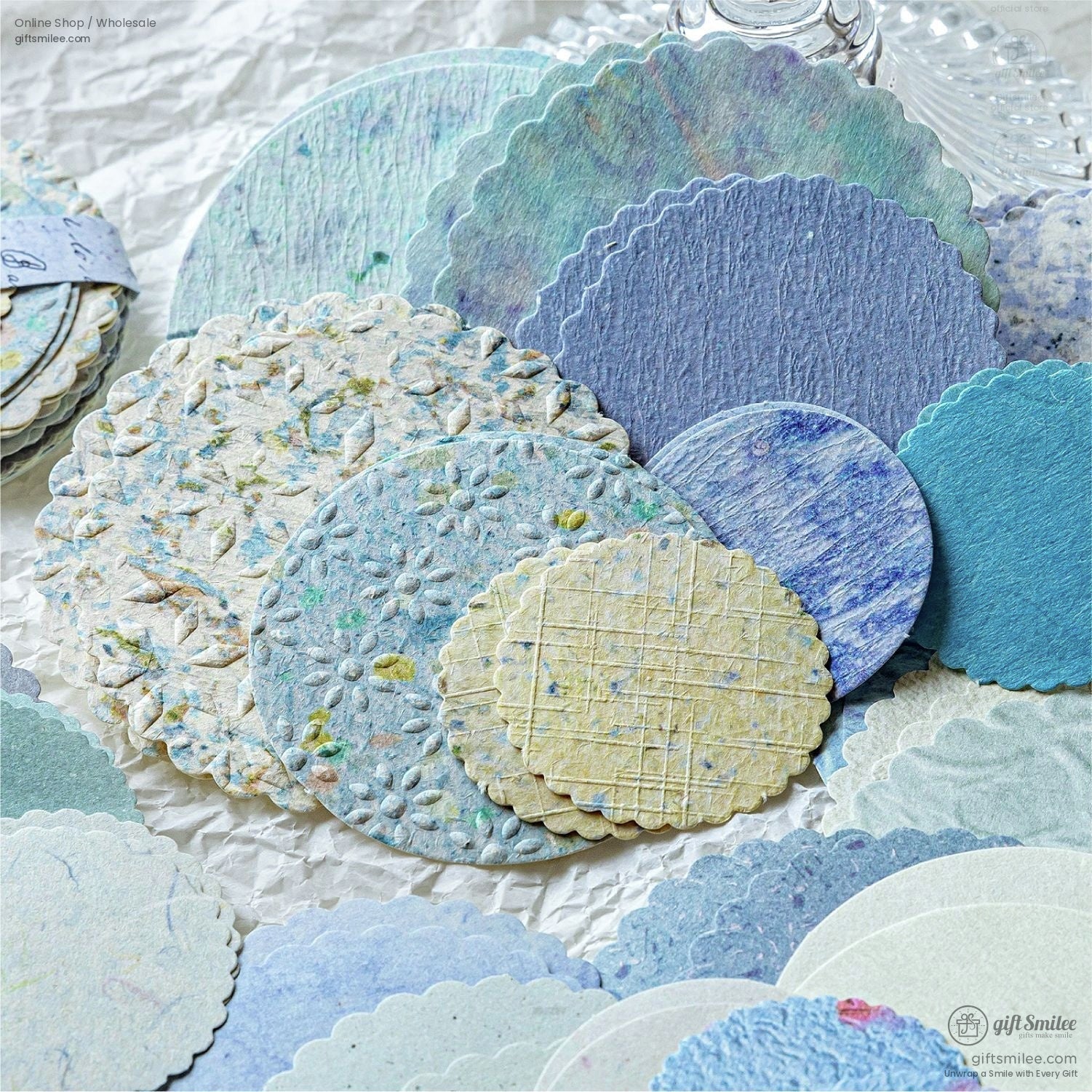Blue and pastel-colored handmade scalloped paper circles with intricate textures and floral patterns