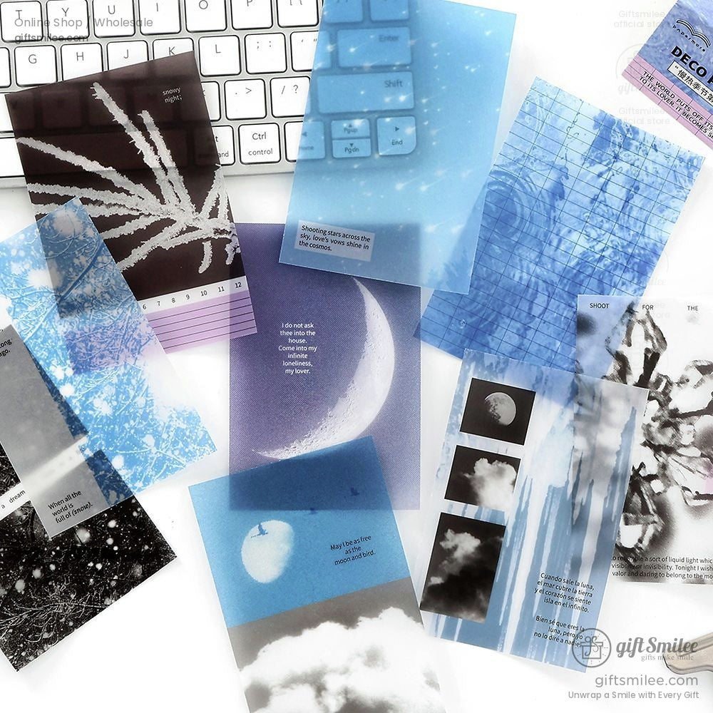 Transparent deco paper sheets with celestial moon and star designs on a keyboard background
