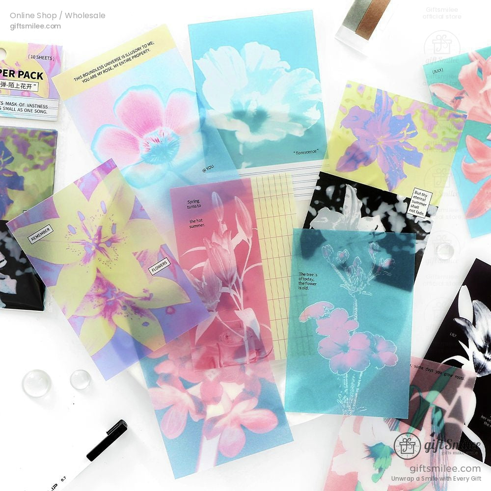 Vibrant floral-patterned transparent journaling sheets spread out creatively