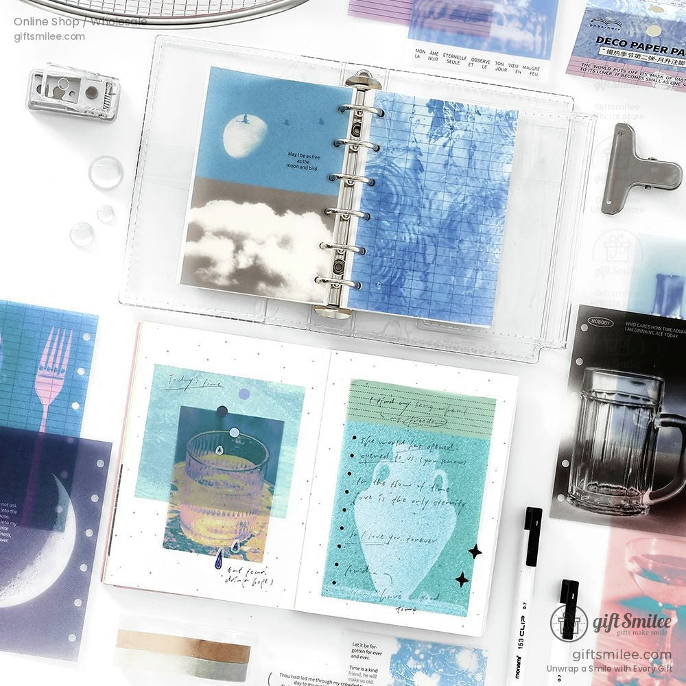 Deco paper sheets displayed in a journal binder with celestial and abstract designs
