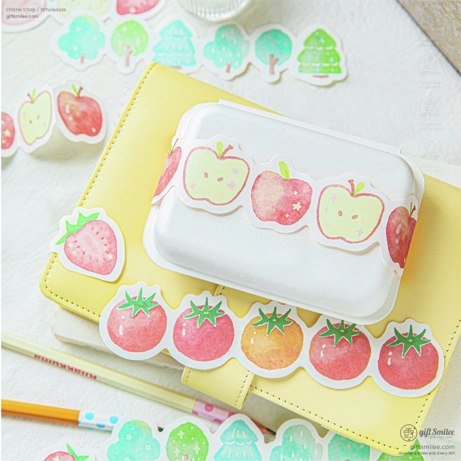 Fruit-themed stickers with apples, strawberries, and tomatoes on a planner