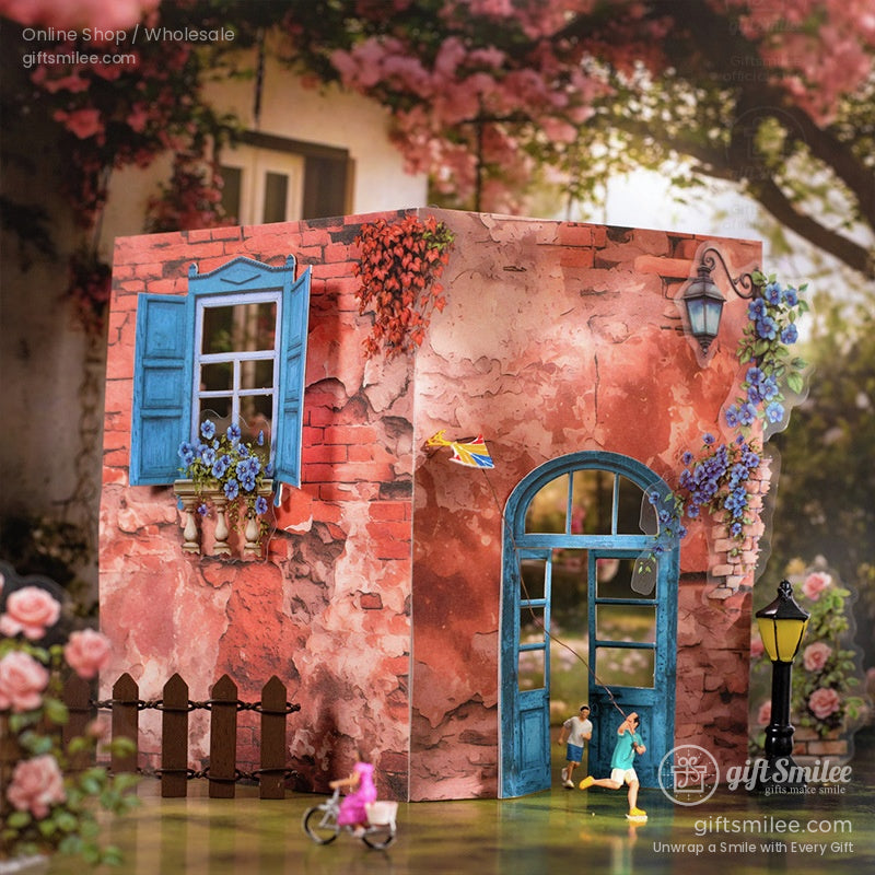 Miniature 3D dollhouse scene with a red-brick house, blue shutters, and floral details under a dreamy pink sky