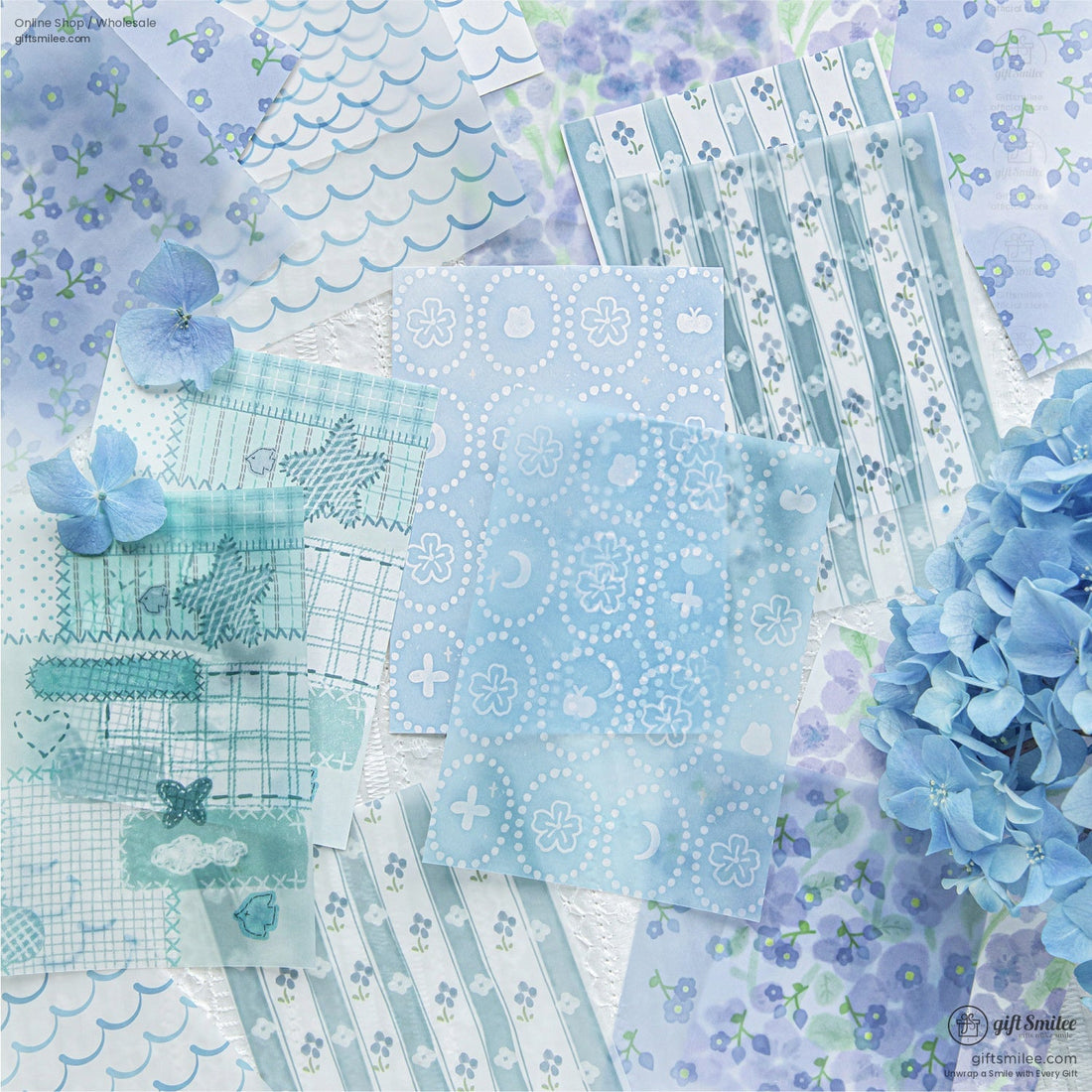 A collection of blue floral and hydrangea-themed scrapbook papers with delicate patterns and designs