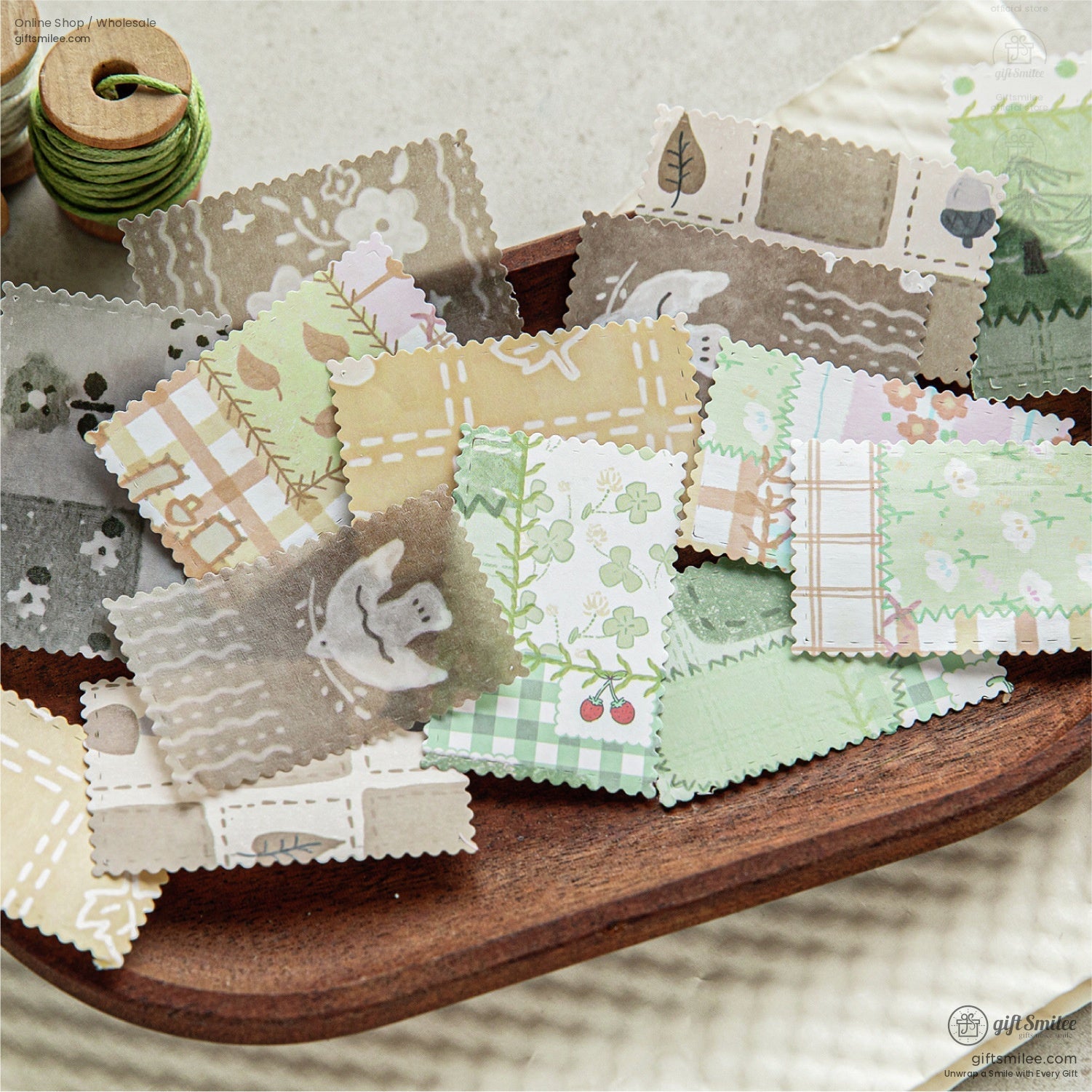 A set of cut-out vintage-style scrapbook paper pieces displayed on a wooden dish