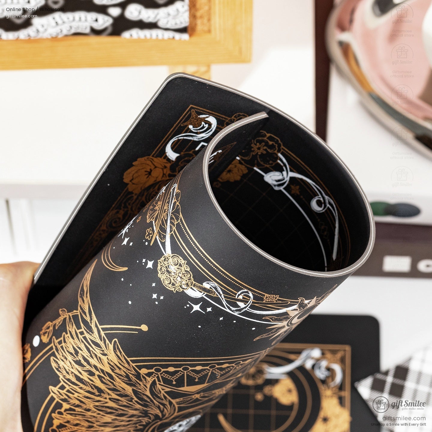 Close-up of rolled black celestial cutting mat showcasing its flexibility.