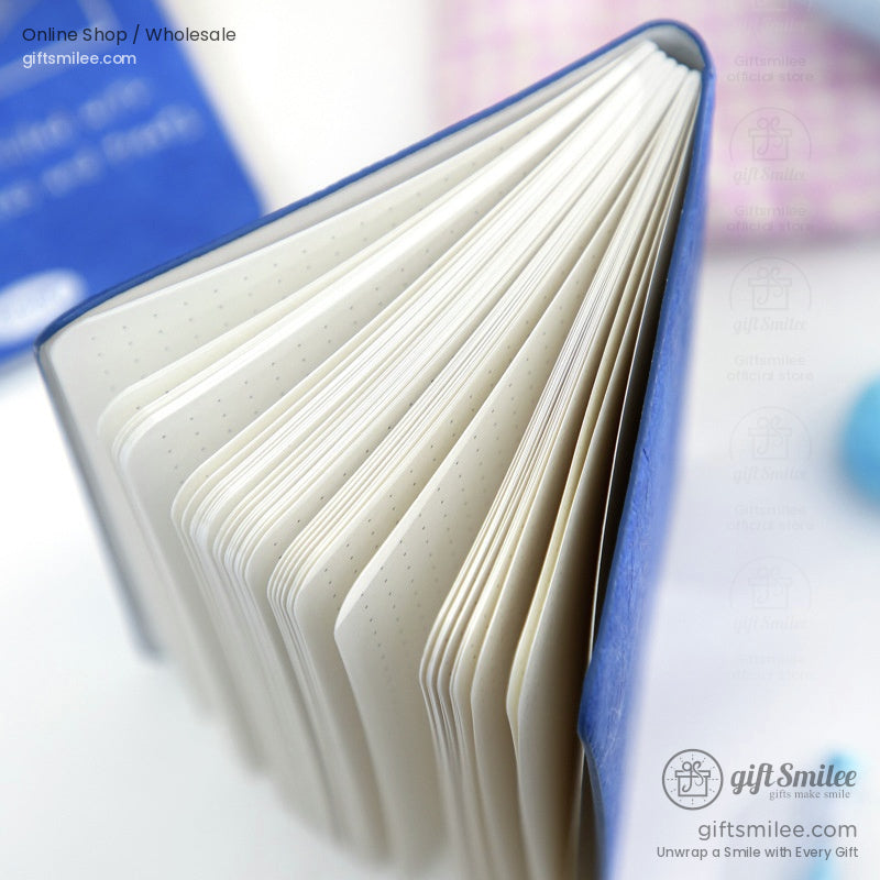 Open blue puppy-themed journal showing dotted pages for creative journaling and writing