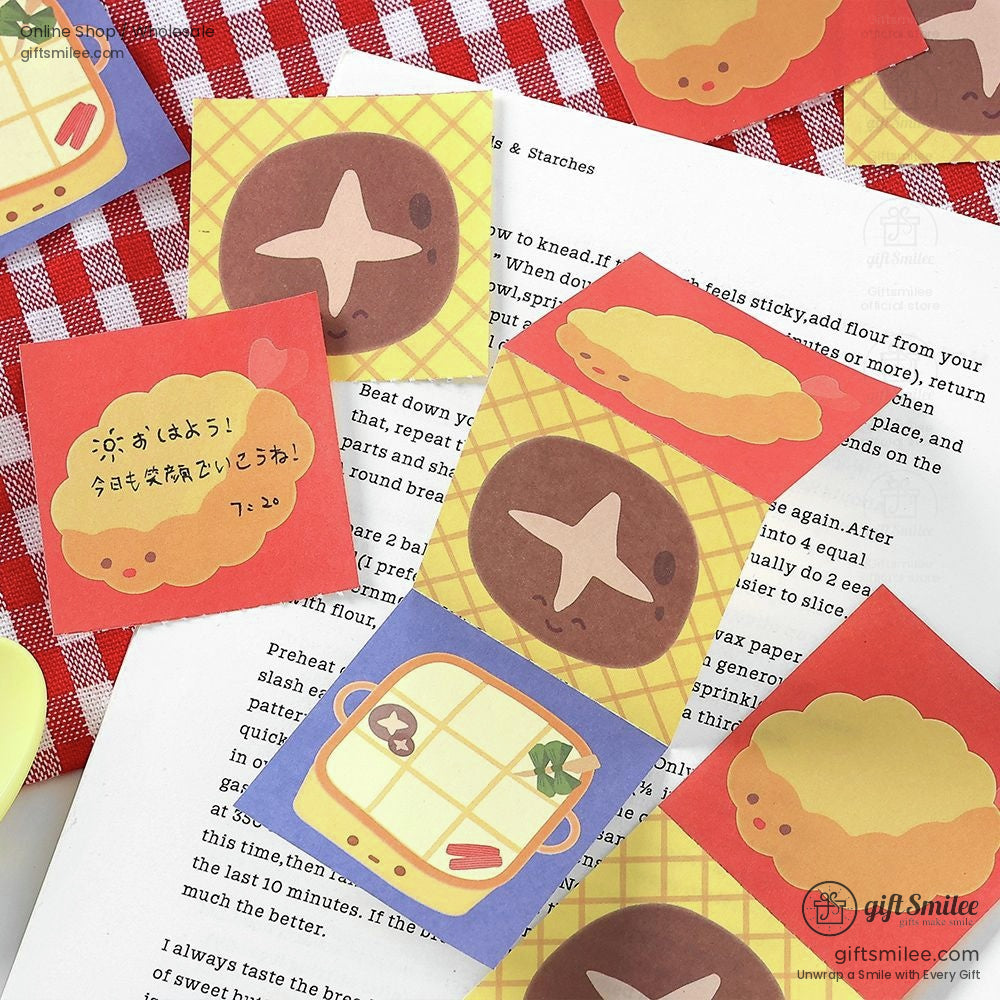 Close-up of kawaii food stickers featuring donuts, waffles, and more on a red gingham cloth