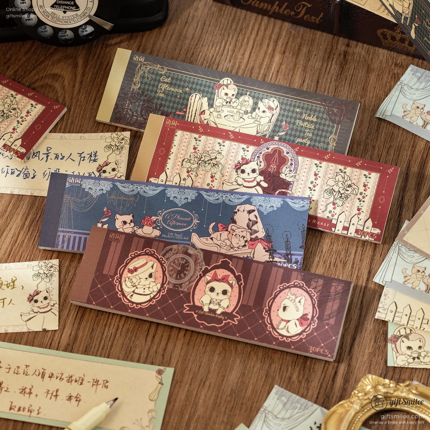 A collection of vintage cat-themed memo pads with intricate designs and floral accents on a wooden desk