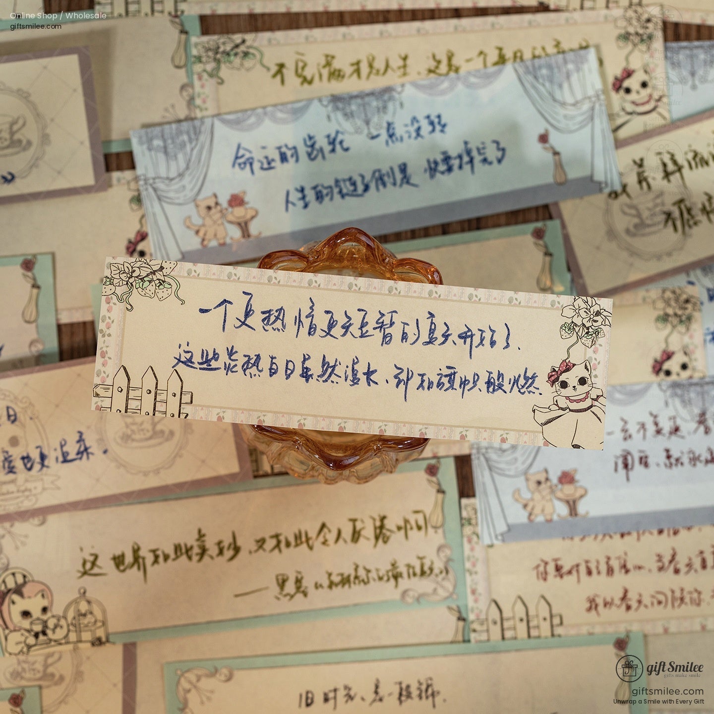 Close-up of cat-themed memo pads with handwritten notes and decorative elements