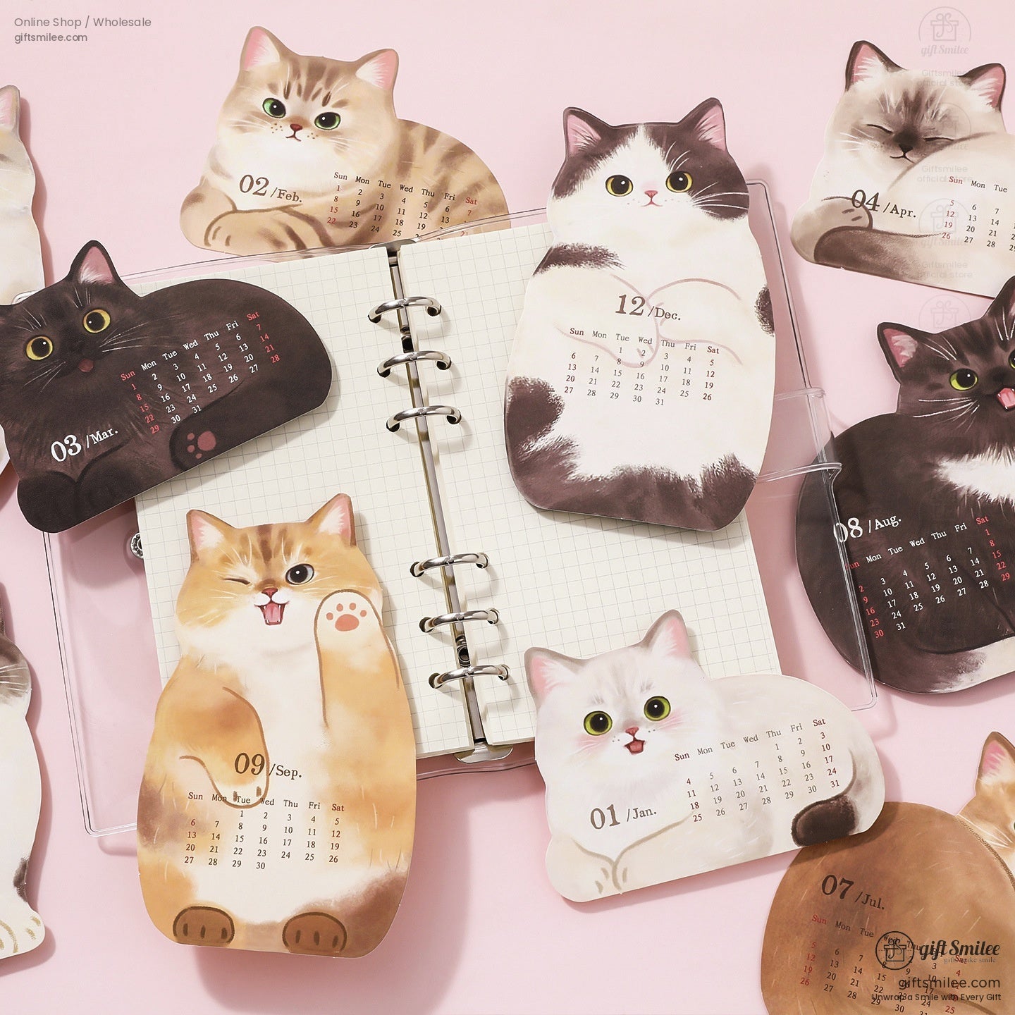 Collection of cat and dog calendar pages spread out with detailed monthly designs