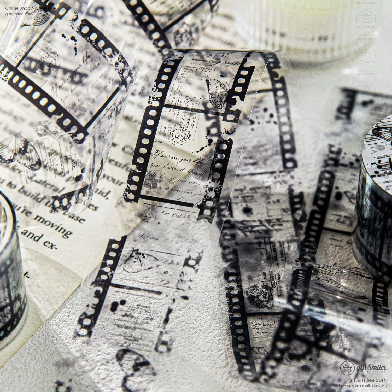 Film strip-themed washi tape unrolled, showcasing retro patterns and delicate vintage textures.