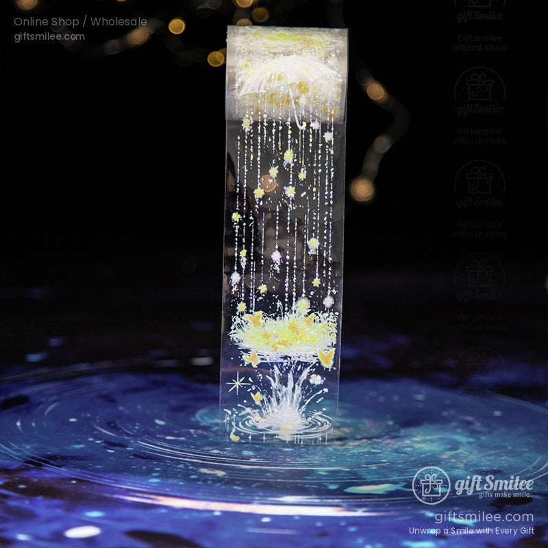 Transparent washi tape featuring a glowing umbrella and cascading raindrops with a celestial theme