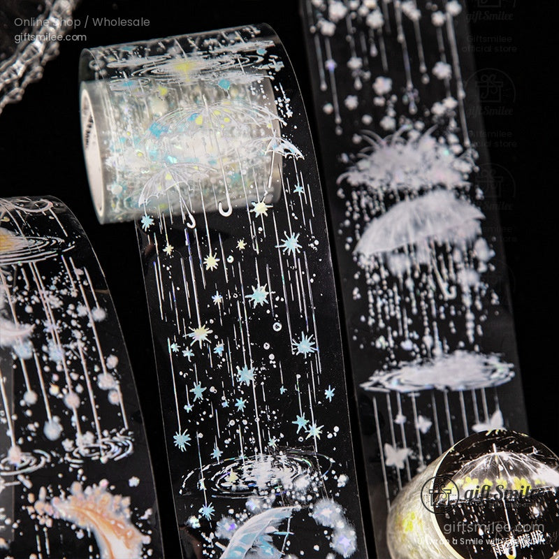 Close-up of decorative washi tape rolls with starry rain patterns and luminous umbrella designs