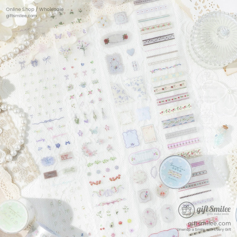 Flat lay of vintage floral washi tape and stickers on lace fabric with pearls