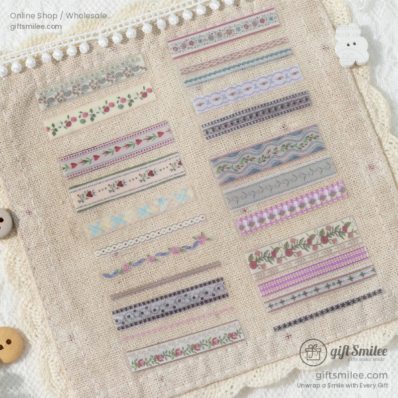 Assorted floral-patterned washi tape strips displayed on burlap fabric