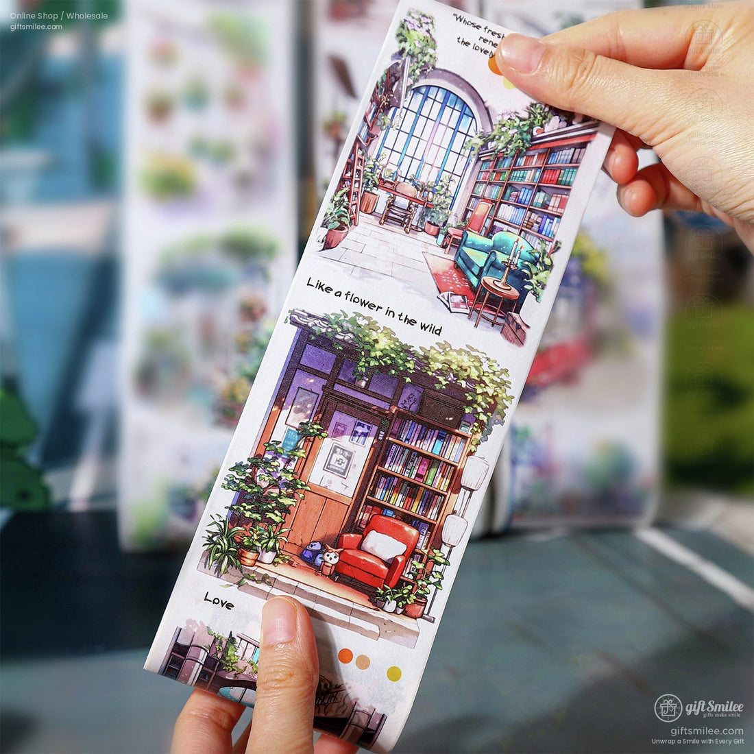 Hand holding vintage floral washi tape with cozy library and garden illustrations