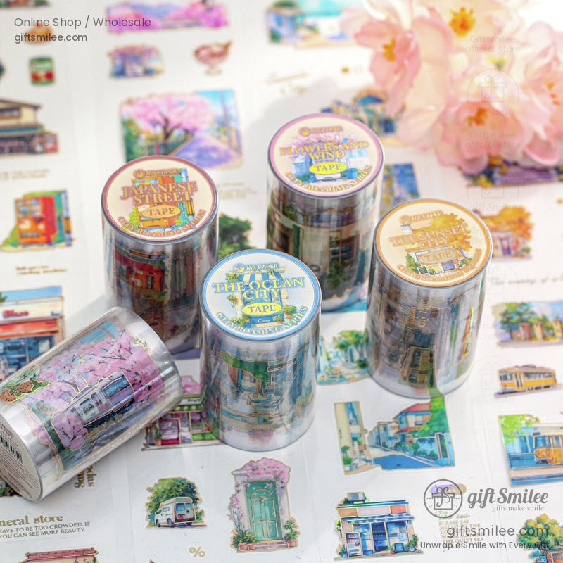 A collection of scenic washi tapes featuring Japanese streets, ocean views, and floral designs displayed with vibrant decor
