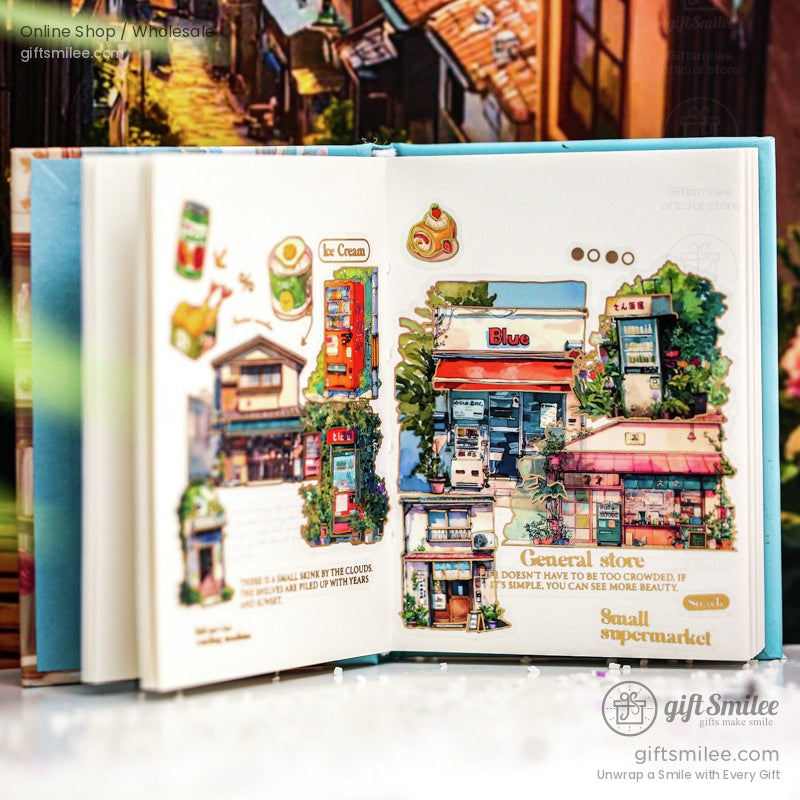 Scenic journaling stickers in a scrapbook, highlighting a general store, countryside buildings, and artistic details