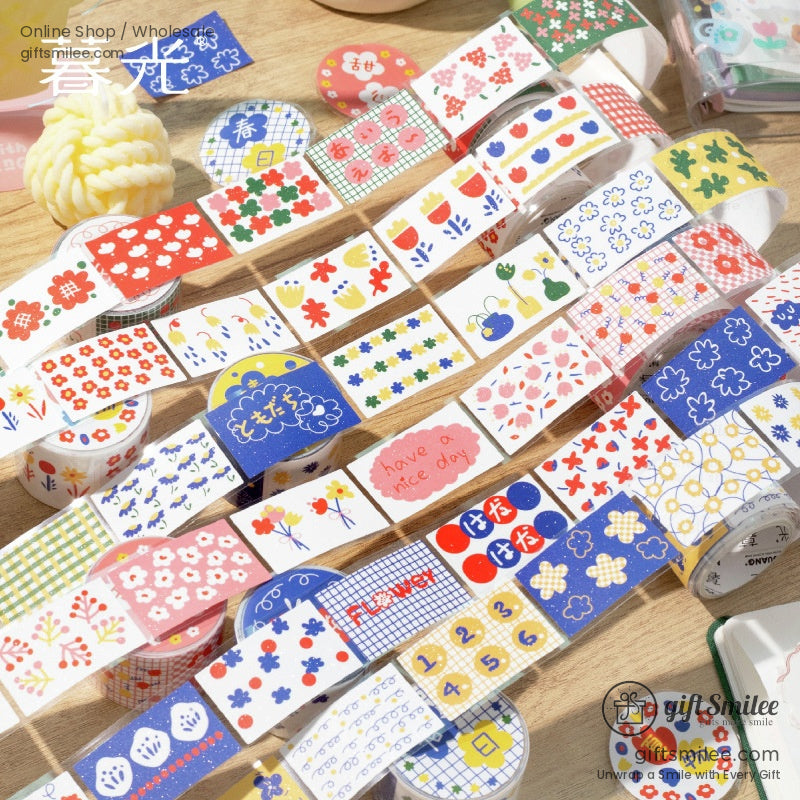 A colorful assortment of floral and patterned washi tape rolls displayed on a wooden surface