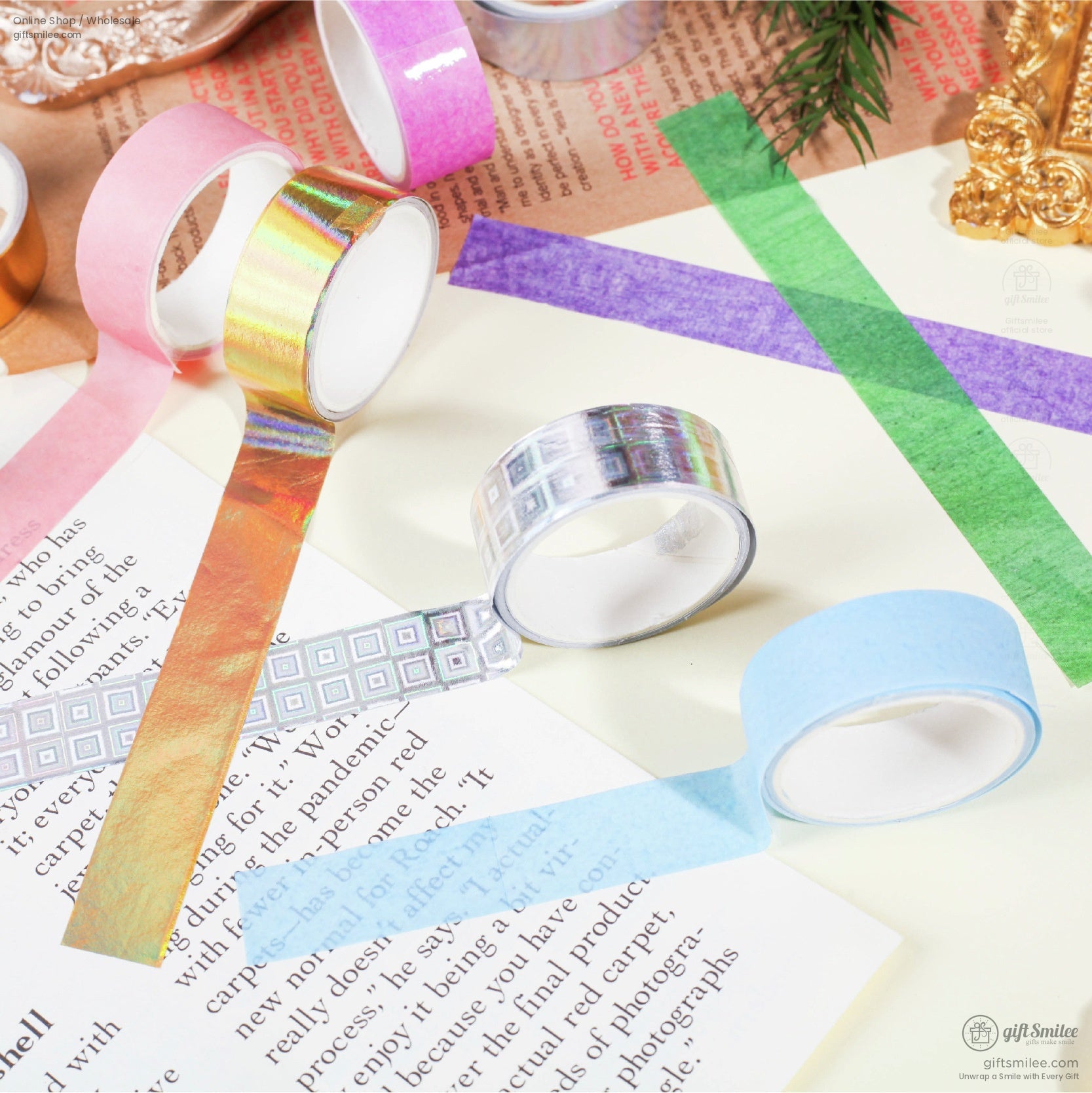 Colorful holographic washi tape rolls on a book and craft table